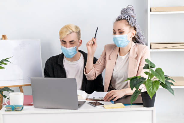 istock Business conference online. Young modern beautiful woman is actively gesticulating while looking into a laptop, reporting to her superiors about the successful work and good results 1303915517