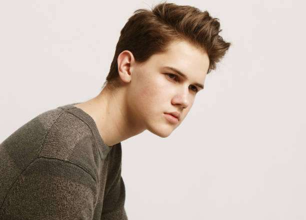istock Attractive teenage boy posing in studio 1303916262
