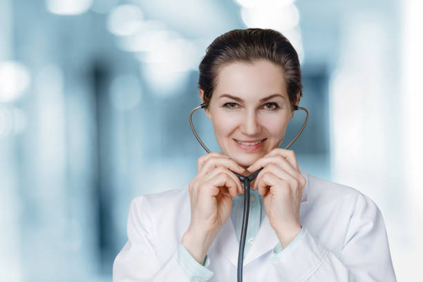 istock Doctor inserts a stethoscope into the ears . 1303917810