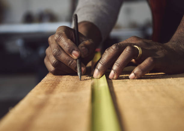 istock Cropped Hands Of Carpenter Working At Workshop 1303920664