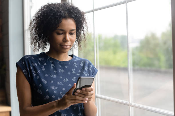 istock Close up focused African American woman using smartphone 1303920927