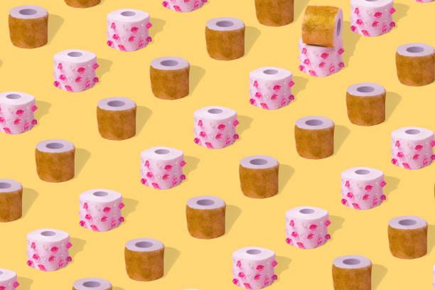 istock Creative idea with toilet paper with diamonds and glitter, pattern on a yellow background 1303920952