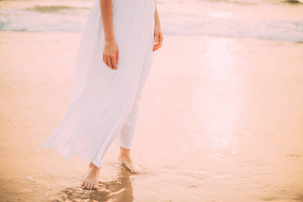 istock Low Section Of Woman Standing On Beach 1303921957