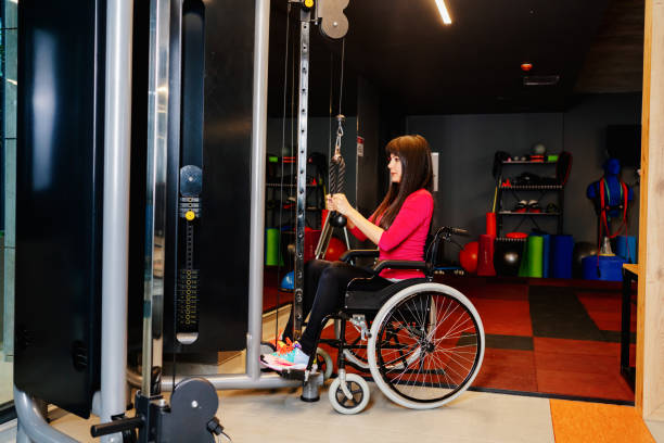 istock Adaptive athlete in a wheelchair lifting weight 1303924999