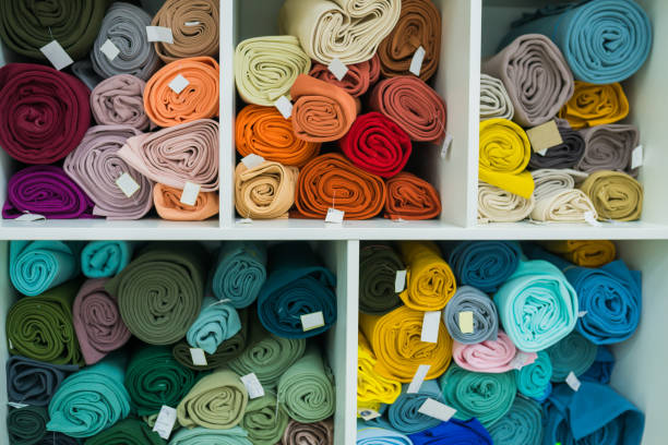 istock Drapery shop. Fabric rolls in textile store. Small business concept 1303925045