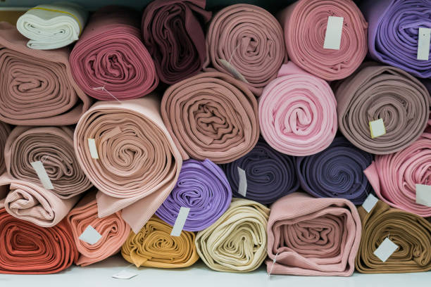 istock Drapery shop. Fabric rolls in textile store. Small business concept 1303925046