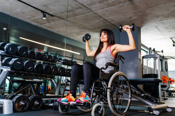 istock Adaptive athlete in a wheelchair lifting weight 1303925132