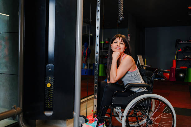 istock Adaptive athlete in a wheelchair lifting weight 1303925327