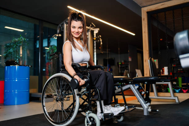 istock Adaptive athlete in a wheelchair lifting weight 1303926387