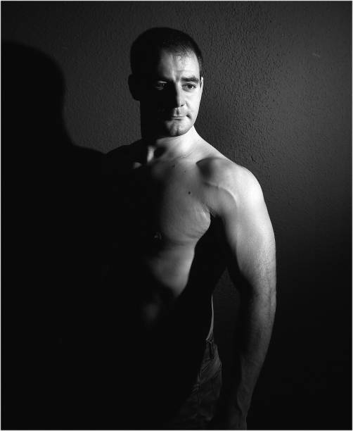 istock a muscular man with shadows 1303926555