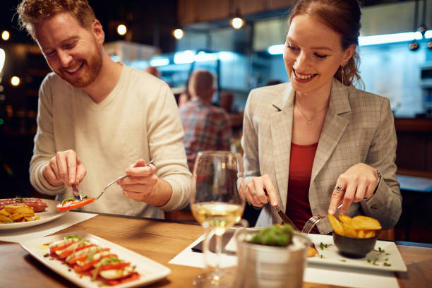 istock Attractive friends sitting in restaurant and having a good time. 1303927471