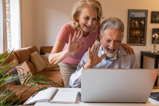istock Happy senior couple at home, using laptop 1303927491