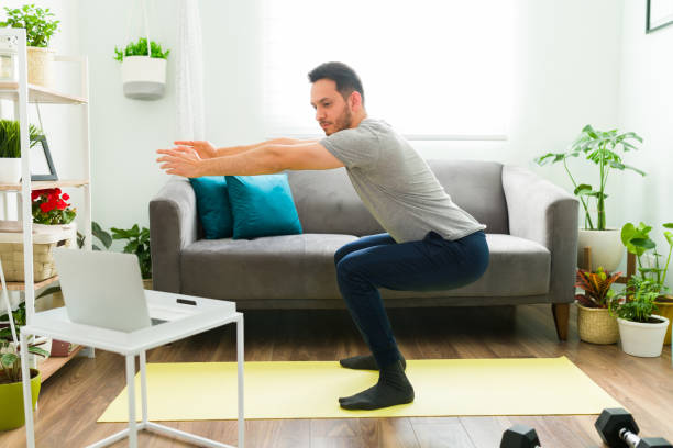 istock Side view of a good-looking man exercising at home 1303927525
