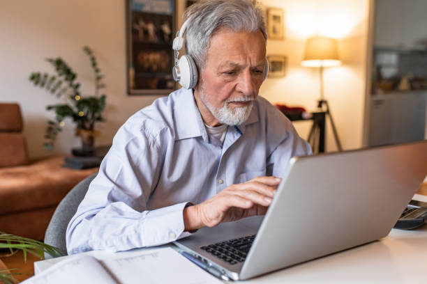 istock Senior man at home, sitting at the desk and using laptop 1303927650