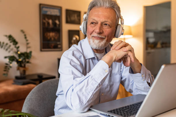istock Senior man at home, sitting at the desk and using laptop 1303927663