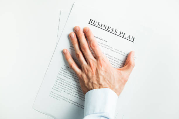 istock Male hand covers the document on the table. Final decision. Acceptance. 1303927817