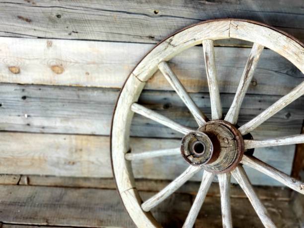 wagon wheel wagon wheel in wild west with barn wood wagon wheel bench stock pictures, royalty-free photos & images