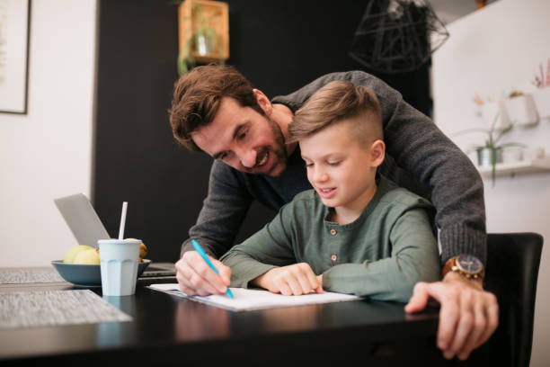 istock Caucasian father with his young son at home 1303929544