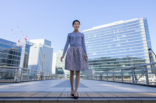 Young Japanese American businesswoman starting new business in new location with confidence and aspirations.