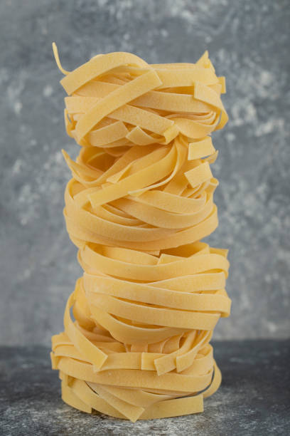 istock Raw dry nest noodles on a marble background 1303937835