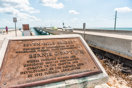 Pigeon Key, USA - May 1, 2018: Old Seven Mile Knights Key-Pigeon Key-Moser Channel-Pacet Channel Bridge by overseas highway road near ocean with sign for Bernie Papy