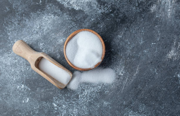 istock Salt in a wooden spoon on a marble background 1303939644