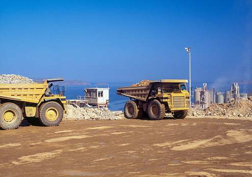 Dumper truck and earth mover in a mining pit, Venezuela