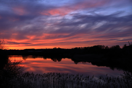 A beautiful colourful spring sunset over the sixfields lake in Northampton, England