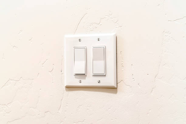 istock Indoor multiple rocker light switch with broad flat levers and cover plate 1303945097