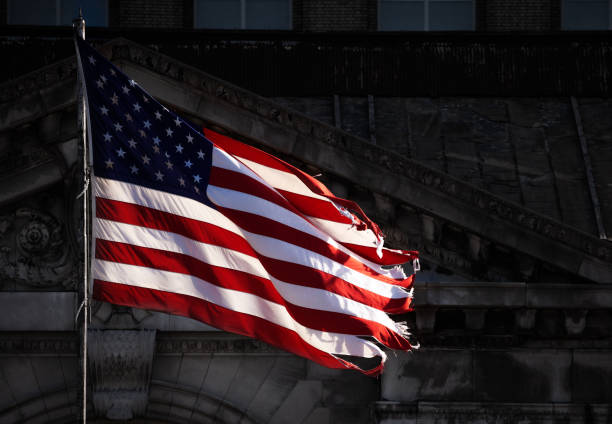 istock Teared apart USA flag and abandoned building 1303952819