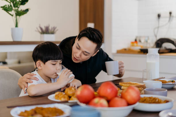 istock Asian Chinese father and son having breakfast together 1303957815