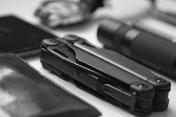 istock everyday  carry ( EDC ) items for men in black color on white background -  flashlight, watch,  multi tool  multitool, phone, pen. Modern city set. Minimal concept. 1303959596