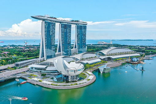 Singapore, June 14, 2019. Aerial view of the famous landmark, Marina Bay Sands in Singapore seen a sunny day. The hotel is shaped like a boat with a large infinity pool on the roof.