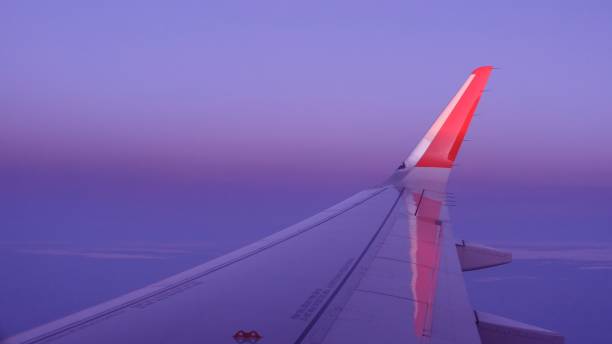 istock airplane window picture with sun on the horizon 1303967335