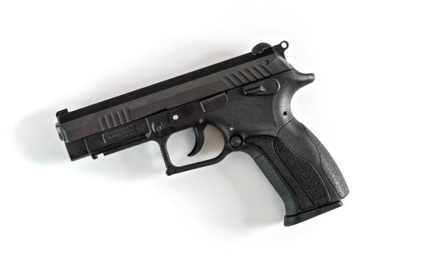 Simple modern black metal gun isolated on white background, view from above