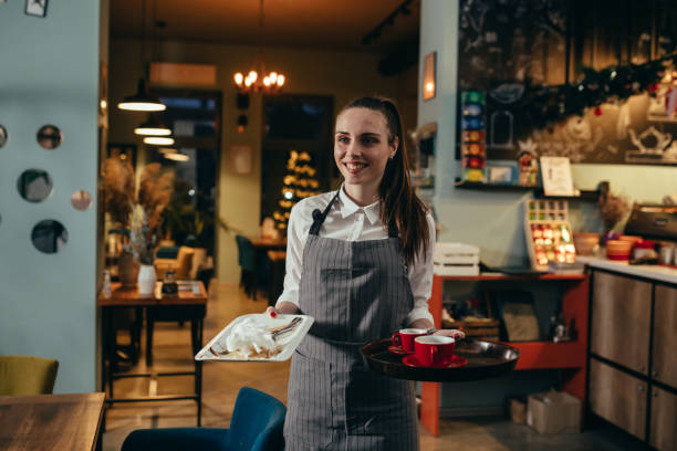 istock waitress working in restaurant of cafe 1303974401