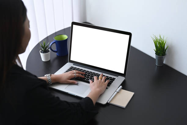 istock Rear view of young woman office worker working on computer laptop while sitting in  calm workplace. 1303975233