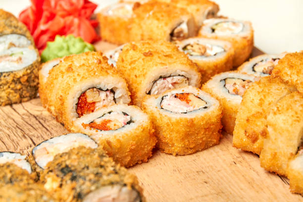 istock Set of various sushi rolls on a board. Close-up, selective focus 1303975242
