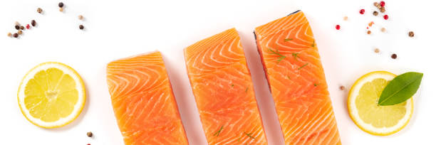 istock Salmon panorama, shot from above with lemon, pepper, and a bay leaf 1303975266