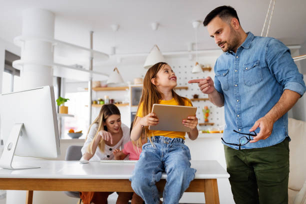 istock Business parents interrupts by her children while working in home office 1303976659