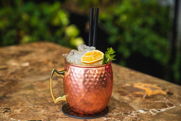 istock Copper jug of cocktail on crushed ice with lime slice and mint leaf 1303977624