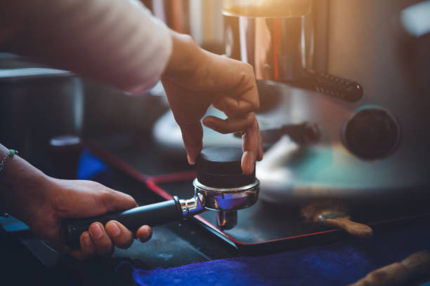 istock Barista making coffee in coffeeshop 1303977784