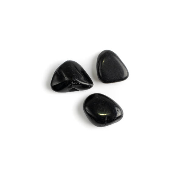 istock Black onyx pebbles isolated, polished hematite gem stones 1303979140