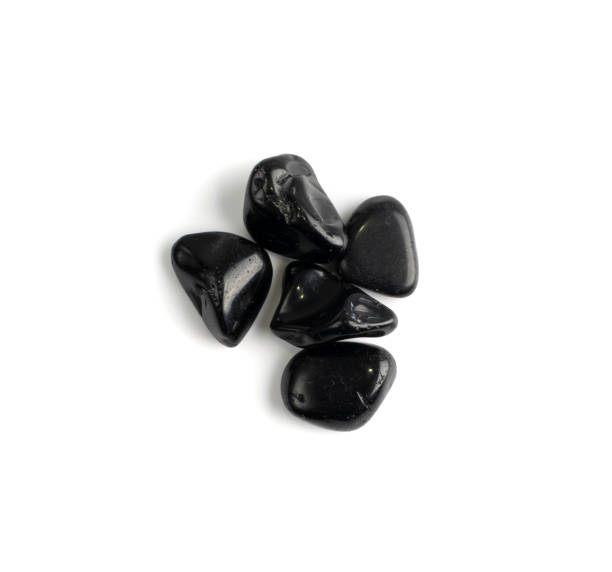 istock Black onyx pebbles isolated, polished hematite gem stones 1303979148