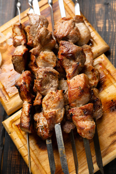 istock kebabs meat on metal skewer on cutting board rustic style 1303981696