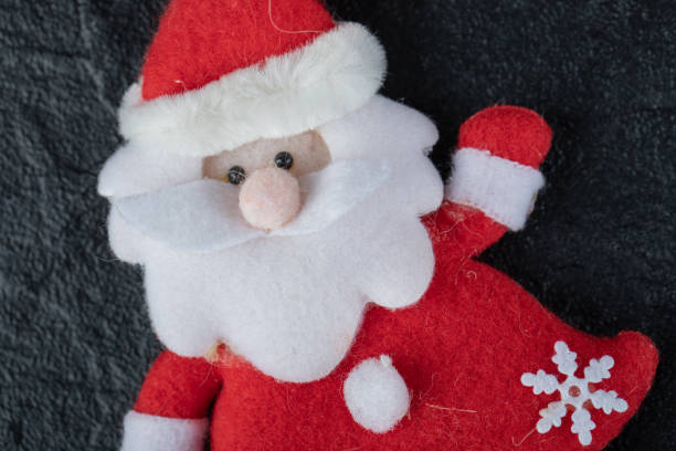 istock Adorable Santa figure on dark background 1303982807