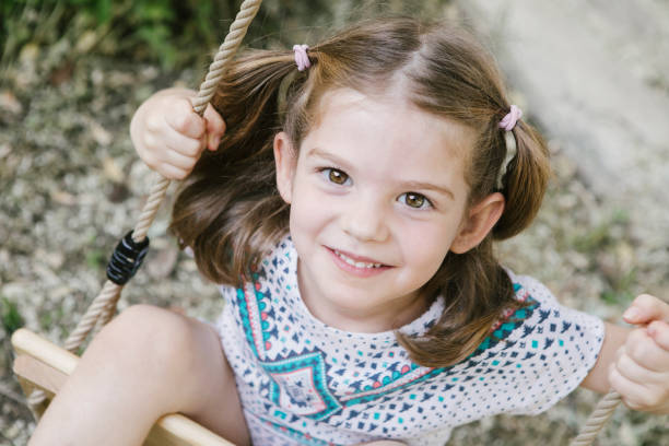 istock Little girl on a swing in park 1303982871