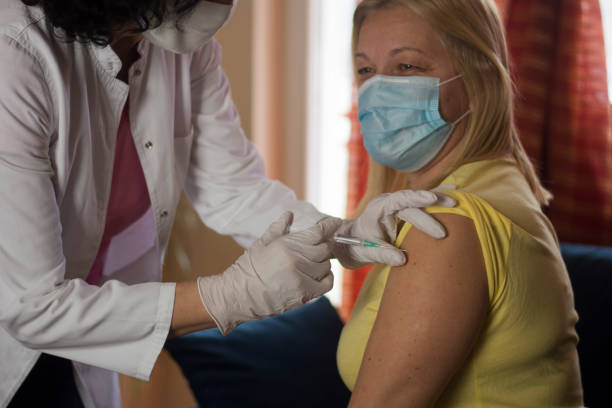 istock Senior woman taking a vaccine 1303982899