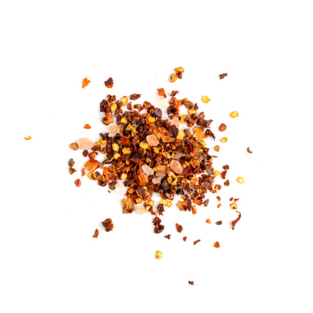 istock Red Chilli Pepper Flakes with Seeds Isolated 1303983327