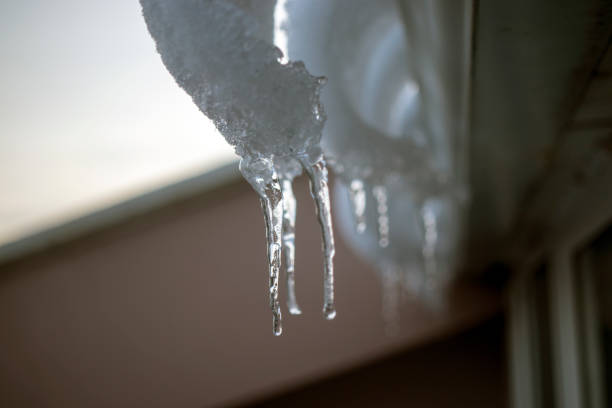 istock icicles hanging from the roof. 1303983517
